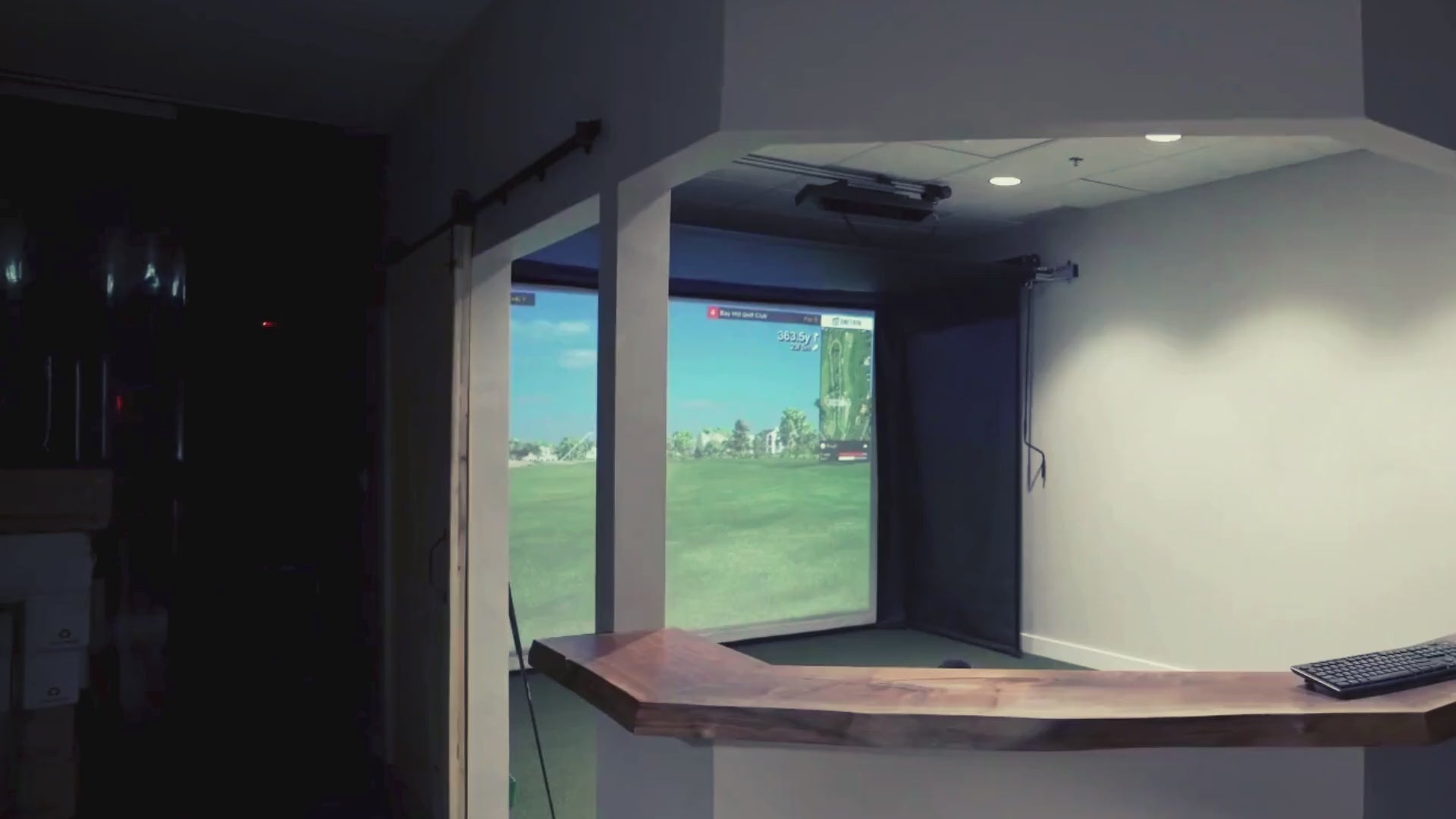 Load video: Home golfers practicing golf with The SportScreen Vanish Retractable Golf Enclosure